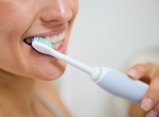 Close up of someone brushing their teeth